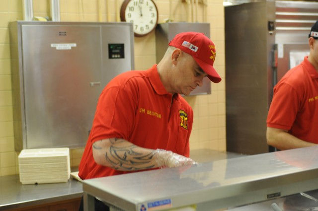 Command Sgt. Maj. Brinton serves chow to Soldiers