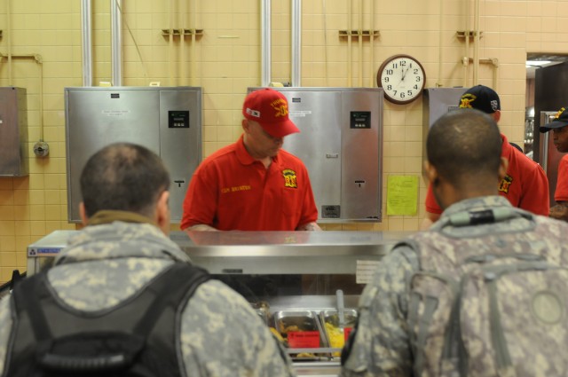 Command Sgt. Maj. Brinton serves chow to Soldiers