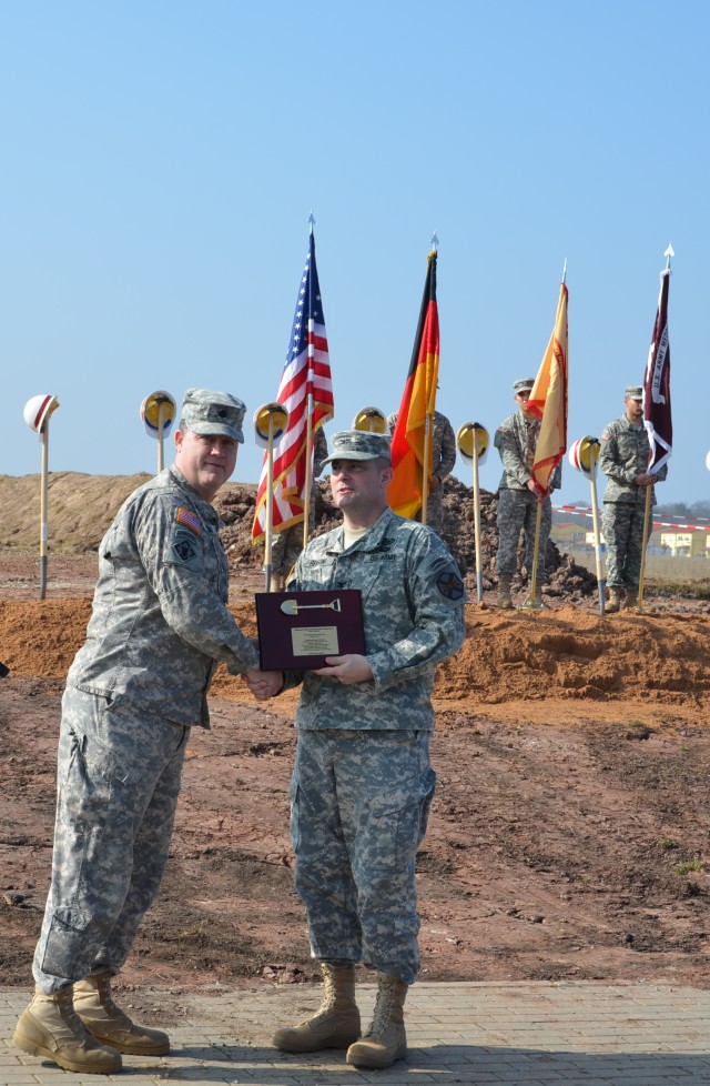 A memorial plaque is handed to the garrison commander during the groundbreaking ceremony of Ansbach's new Health and Dental Clinic.