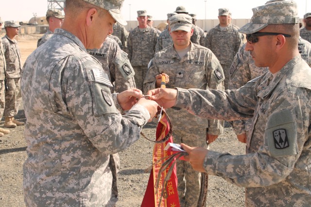 BG Dickinson and CSM Dominguez award the streamers to D Battery