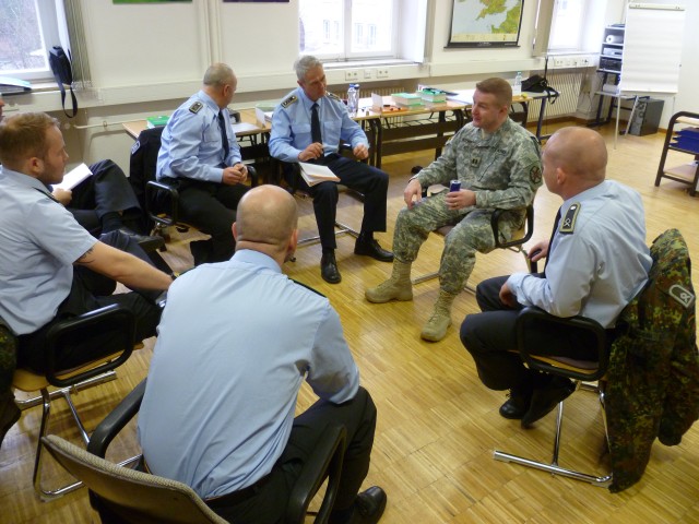 Capt. Chris Meserve talks to participants of an English language seminar