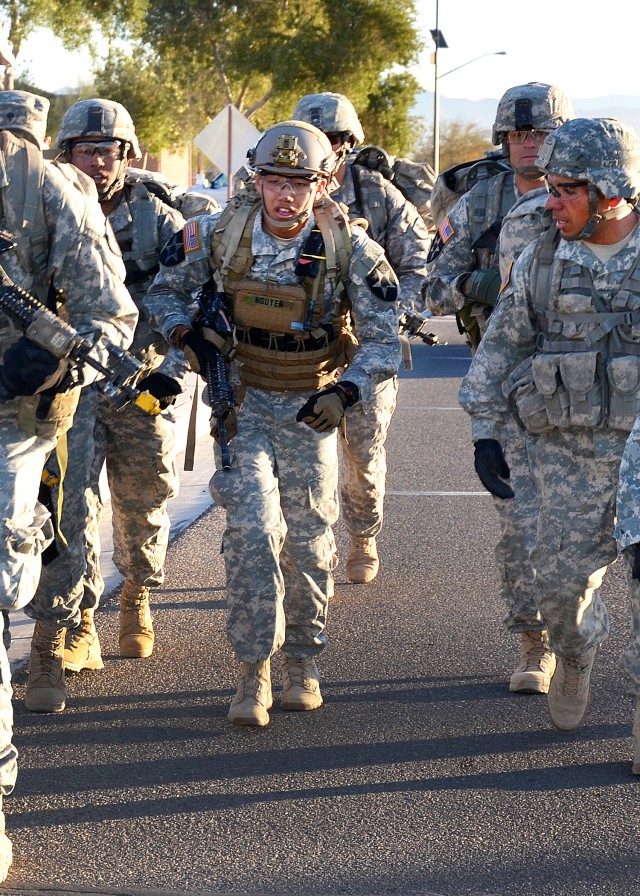 Spc. Kevin Nguyen conducts a six-mile road march