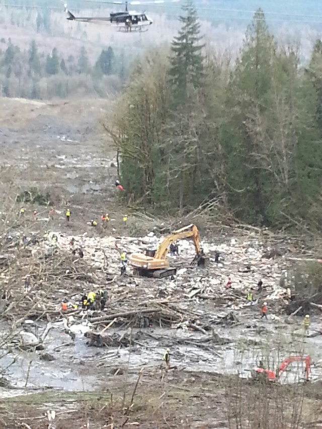 Recovery crews search a debris field in Oso, Wash. March 25. Melissa Daniels, a 'future Soldier' who recently enlisted in the Army, assisted crews during recovery efforts.