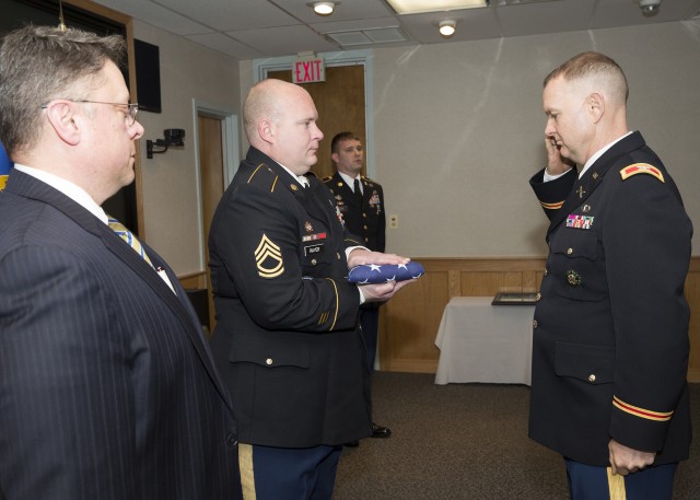 Explosives ordnance technician who 'died twice' gets solemn retirement