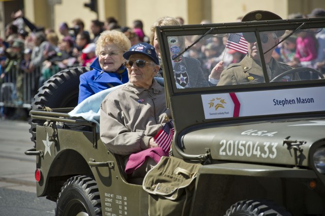 U.S. Army veteran Stephen Mason and his Czech wife smile and wave to onlookers during the Pilsen Liberation Festival parade