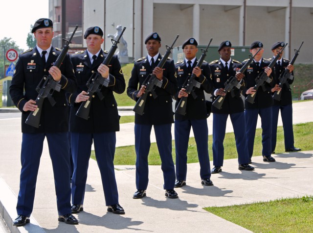 Soldiers stand ready to fire a salute at the memorial ceremony  in honor of Spc. Carl A. Lissone