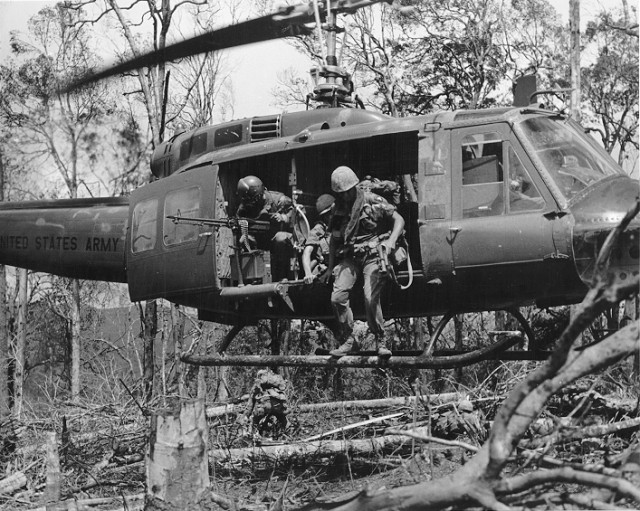 Screaming Eagle Soldier exit a Huey during an Air Assault mission in Vietnam.