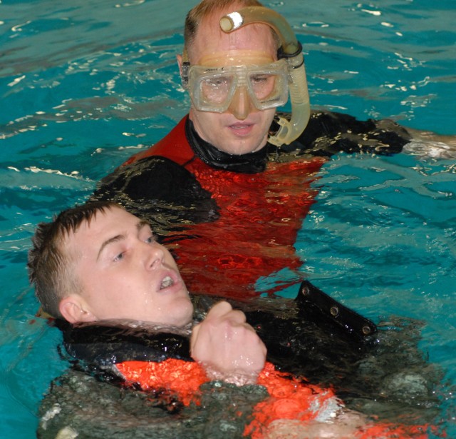 Coast Guard Chief Petty Officer Charlie Fowler, Aviation Safety Technician and rescue swimmer from USCG Air Station Pilots receive water evacuation training from Coast Guard rescue swimmers photo by S