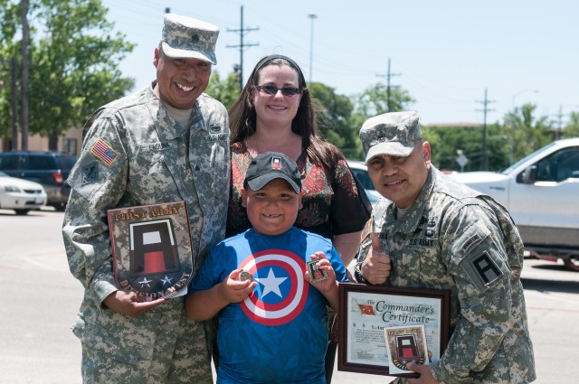 CSM  Akuna presents certificate to young fan of DivWest