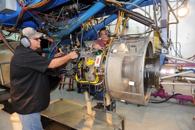 CCAD employees work on helicopter