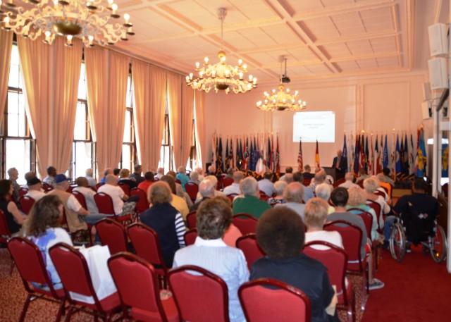 Retirees listen to a briefing in the ballroom