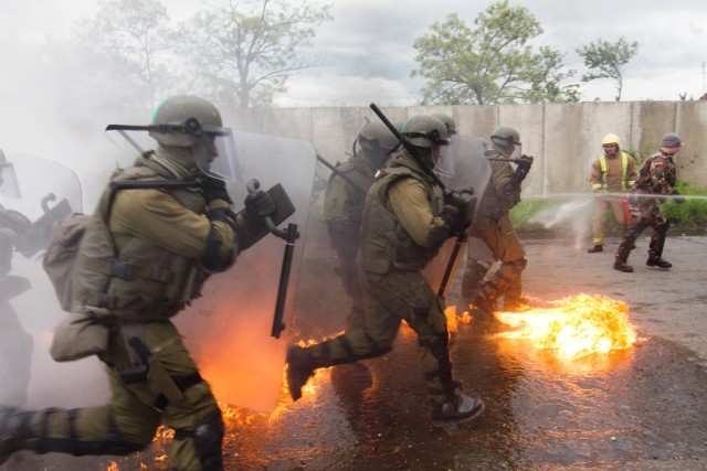 Austrian Soldiers charge towards rioters