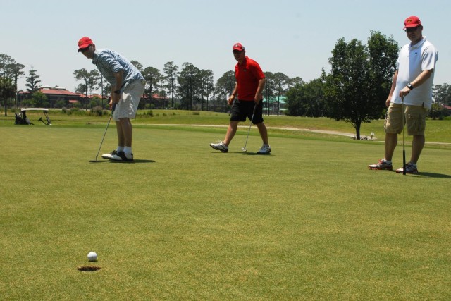 Vanguard staff tee off in golf scramble