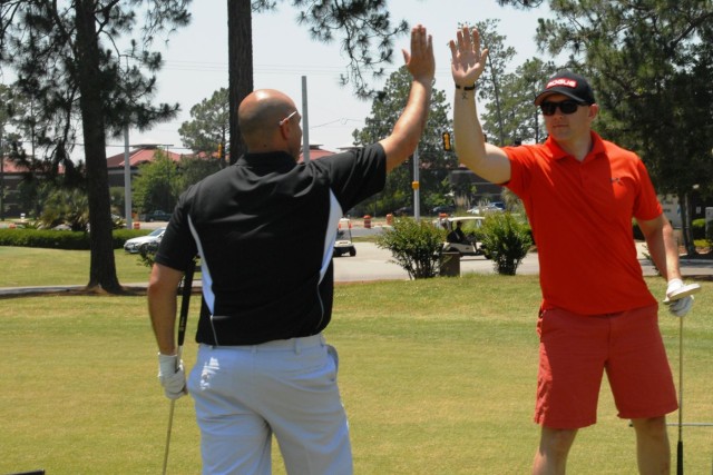 Vanguard staff tee off in golf scramble