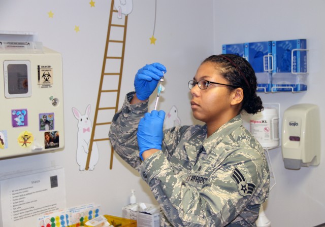 Air National Guard member prepares immunization