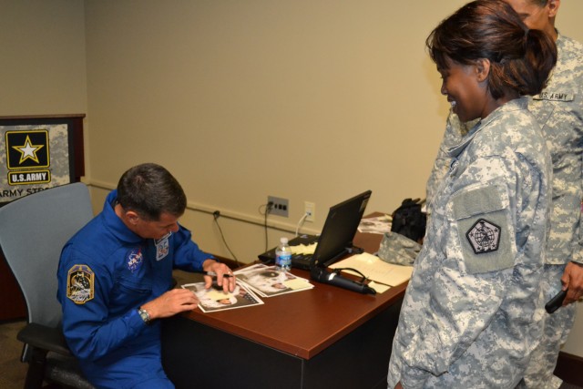 Col. Shane Kimbrough autographs a photo of himself