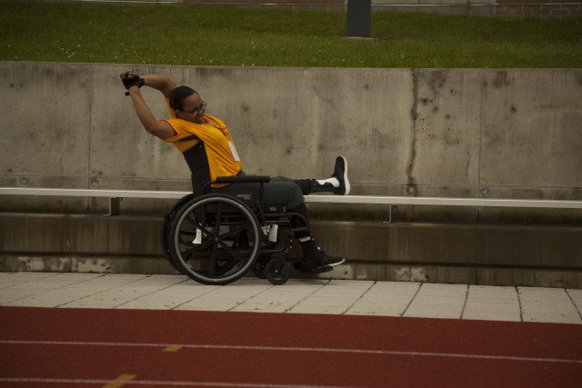 Army Sgt. Carlita Harter stretches prior to a cycling practice for 2014 U.S. Army Warrior Trials