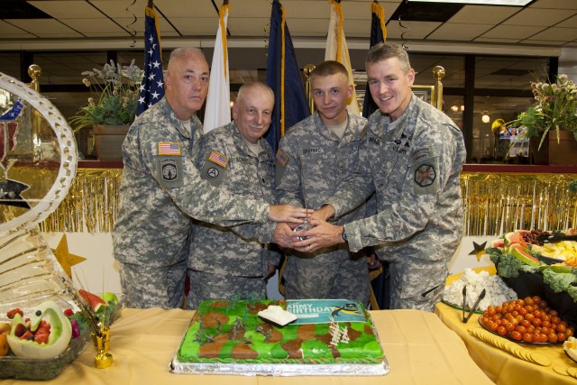 Garrison leadership cutting Army birthday cake