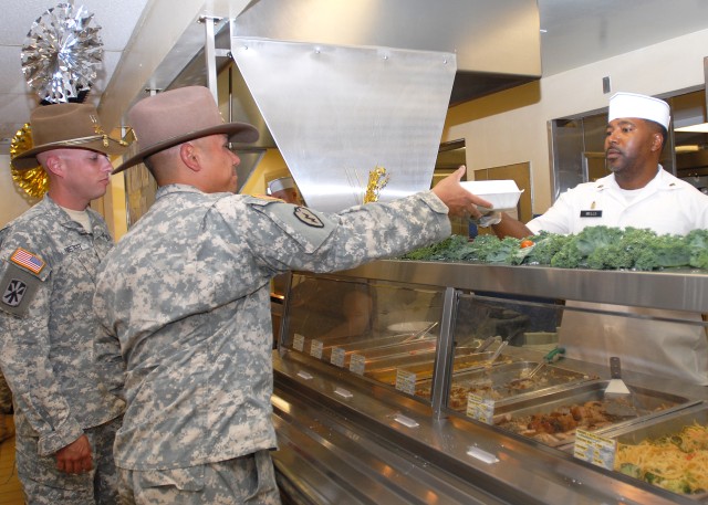 Soldiers receive food at dining facility