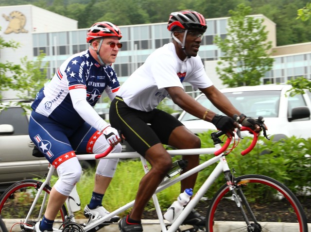 Staff Sgt. Sean Johnson (ret.) practices cycling for the 2014 Army Warrior Trials with Sgt. 1st Class, Brian Mathis, Warrior Transition Unit Cadre