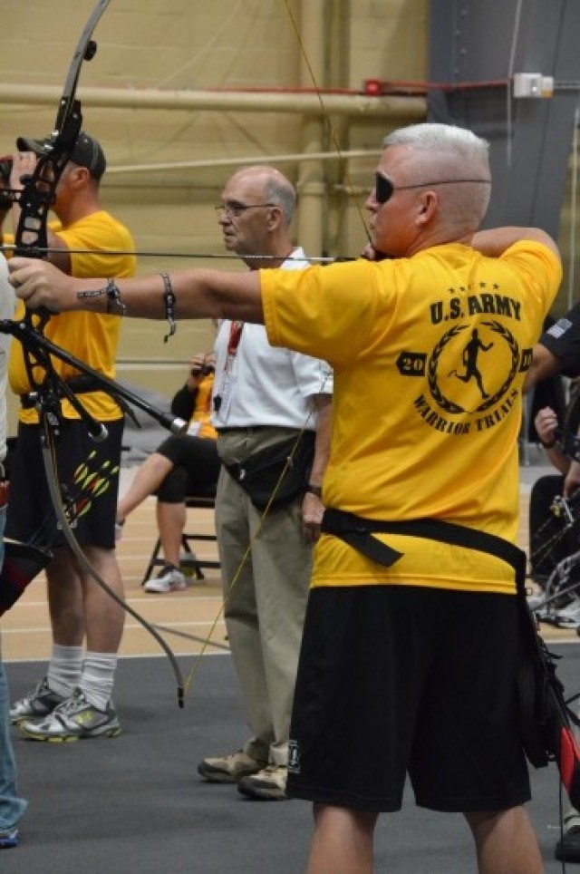 Cpt. Phillips focuses on the archery target during training at the 2014 Warrior Trials