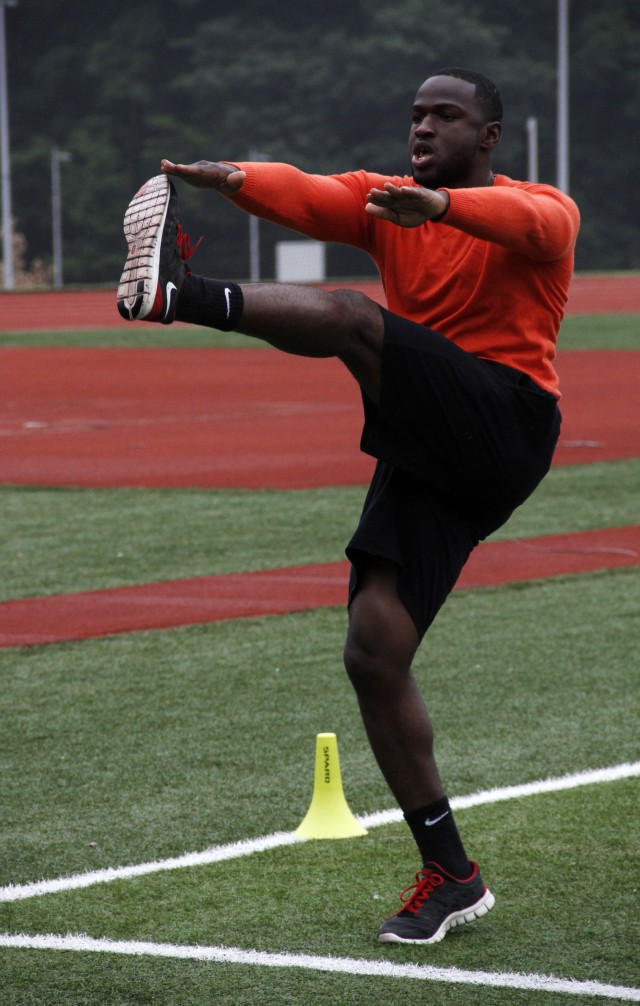 Pfc. Stafford, Army National Guard, Fort Steward, GA, stretches for the 2014 Warrior Trials