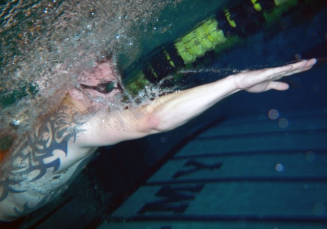Lance Cpl. Fellows, U.S. Marines, Warrior Transition Battalion, swims through the practice lane at the 2014 Warrior Trials