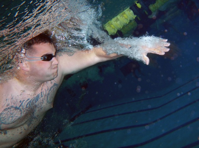 Cpl. Hammands, U.S. Marines, holds his breath during an underwater swim practice for the 2014 Army Warrior Trials