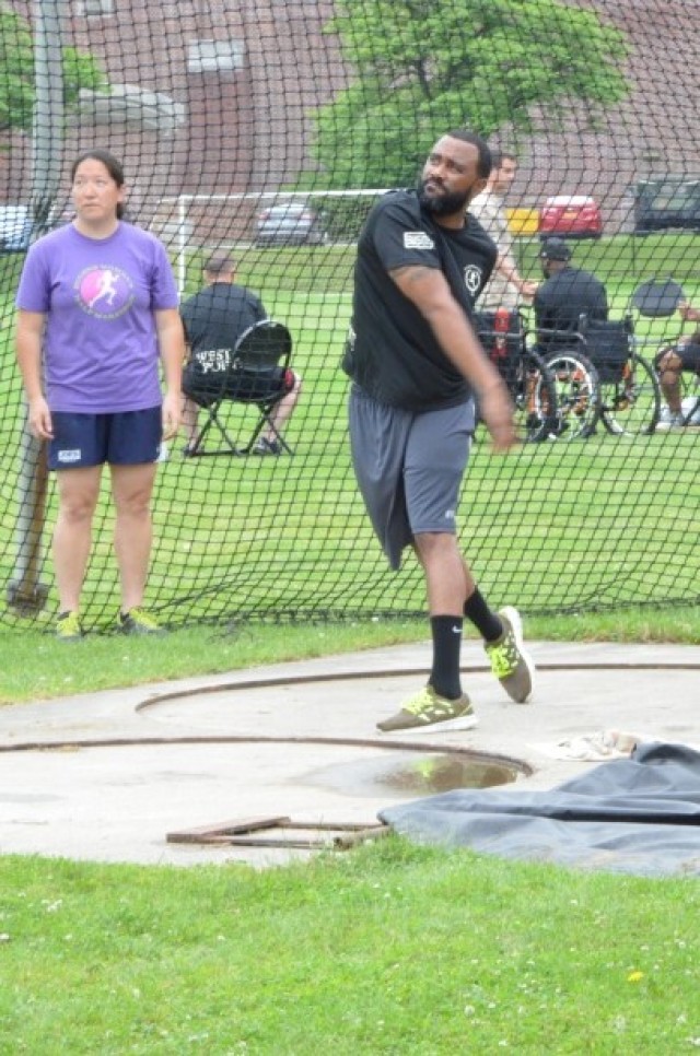 Sgt. 1st Class Hall, throws the discus while practicing at the 2014 Army Warrior Trials