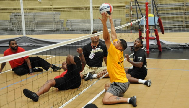 Sgt. Eric Pardo blocks a ball during sitting volleyball practice