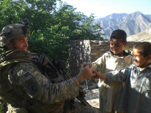 Cpl. Jason M. Bogar with Afghan children