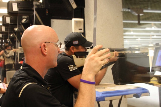 Rick Johnson, U.S. Military Academy assistant rifle coach, offers guidance during shooting competition at U.S. Army Warrior Trials