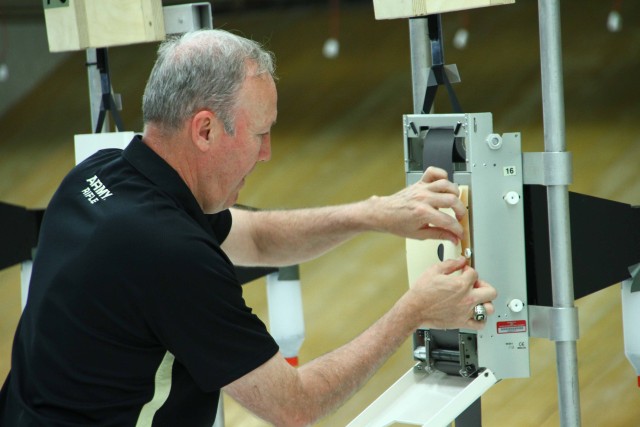 Ron Wigger, U.S. Military Academy rifle coach, adjusts targets during shooting competition at the U.S. Army Warrior Trials