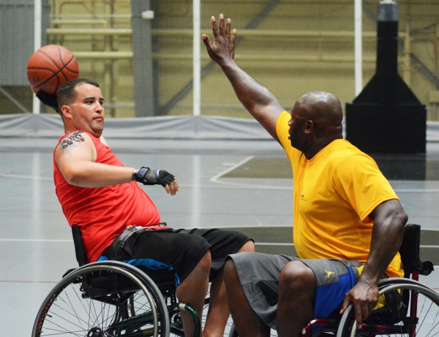 Sgt. 1st Class Jermeka Johnson, Fort Benning, Ga., tries to block Marine athlete, Cpl. Brandon Hammonds