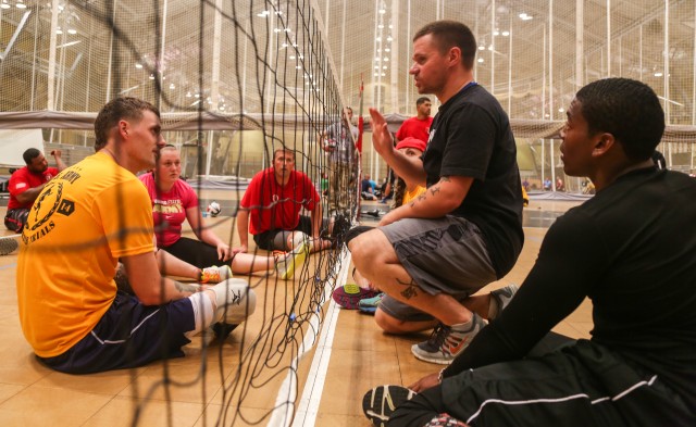 Coach J.D. Malone gives advice to Soldiers and Veterans at sitting volleyball practice at the 2014 U.S. Army Warrior Trials