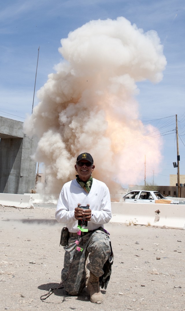 Frank Pope sets off an "explosion" much like those used in training at the National Training Center on Fort Irwin.