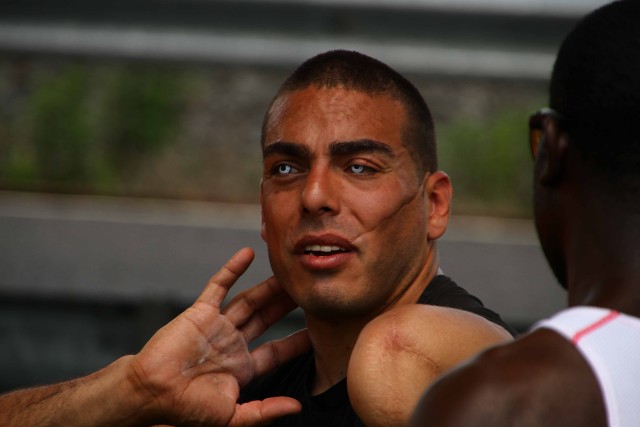 Retired Staff Sgt. Kacer shows a fellow soldier his technique during the 2014 Warrior Trials