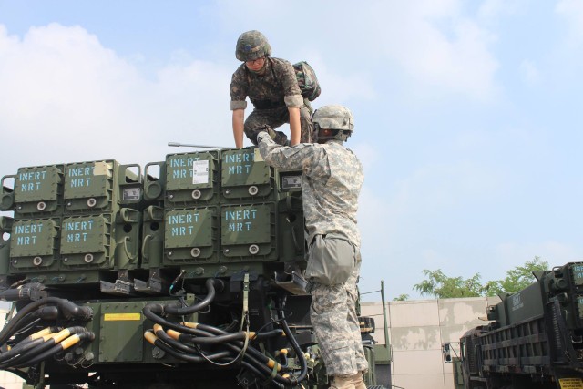 Republic of Korea troop and U.S. Soldier prep equipment for training