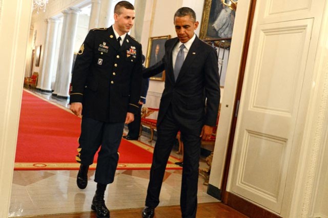 President Barack Obama and Staff Sgt. Ryan Pitts enter the East Room