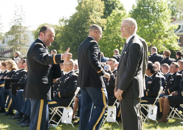 Army War College students give the thumbs up at graduation