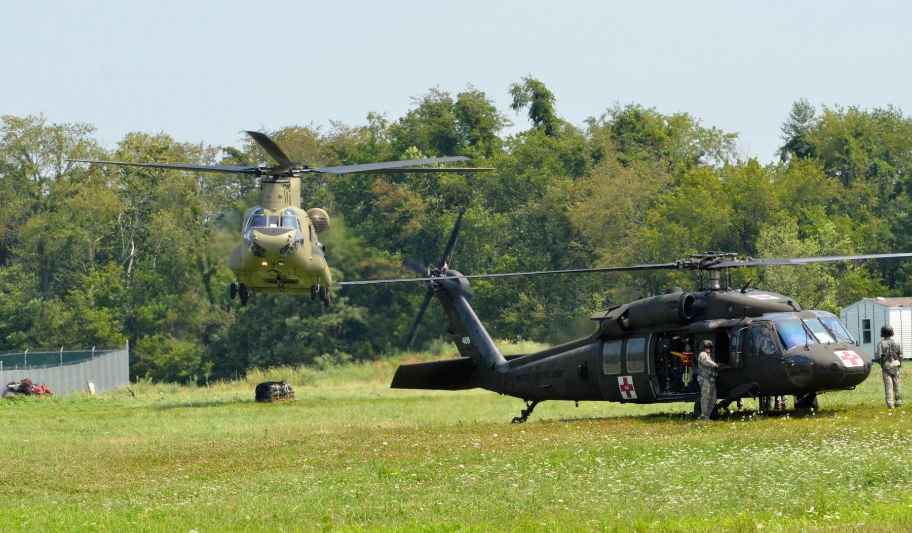 A CH-47 Chinook helicopter drops off simulated load of supplies ...