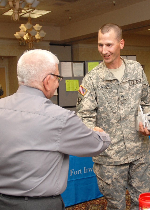 SGT Philip Schmuck shakes hands with John Valentine