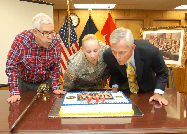 Blowing out candles on cake for Army JAG Corps birthday