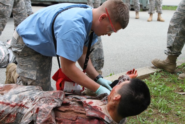 Medical staff from the 121st Combat Support Hospital perform triage on simulated patients