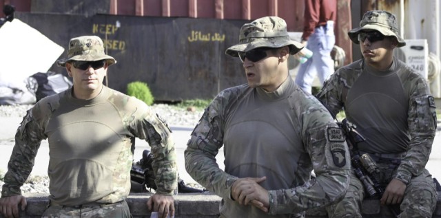 US Army Spc. Robert T. Mikus briefs his fellow platoon members on 'react to contact' prior to a patrol