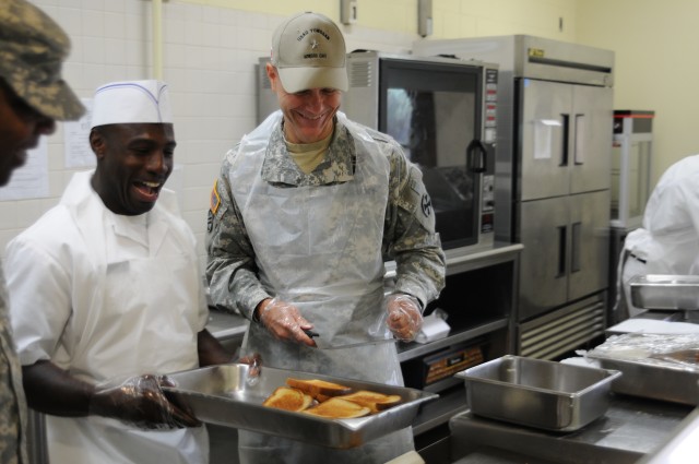 Brig. Gen. Chris R. Gentry cooks grilled cheese sandwiches at Honors Cafe, Yongsan Garrison, Korea 17 Sep. 2014.