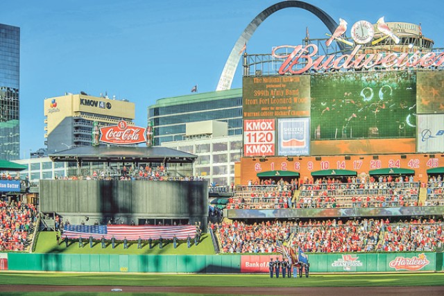 members of the St. Louis Cardinals stand for the National Anthem