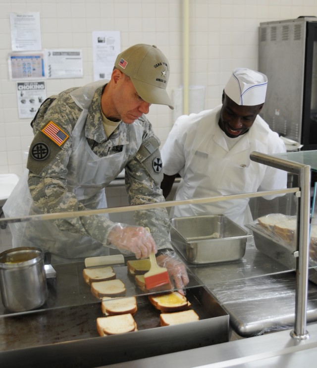 Brig. Gen. Chris R. Gentry cooks grilled cheese sandwiches at Honors Cafe, Yongsan Garrison, Korea 17 Sep. 2014.