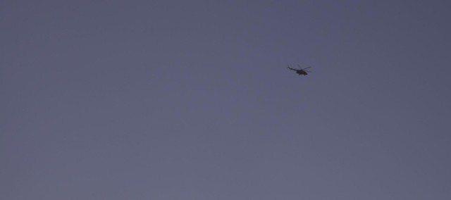 Afghan air force helicopter flies over Forward Operating Base Gamberi