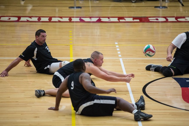 Sgt. Scotty Hasting dives for the ball in sitting volleyball